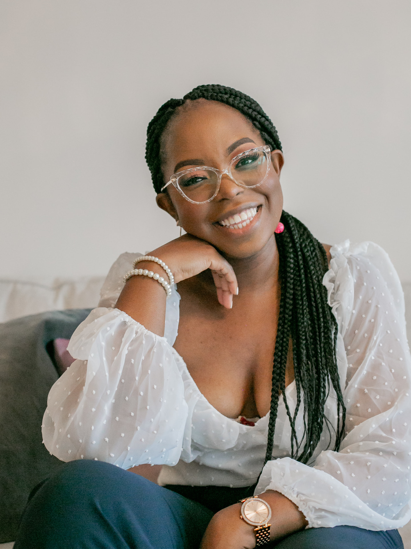 Photo of Ekaete Inyang smiling in a sheer cream blouse